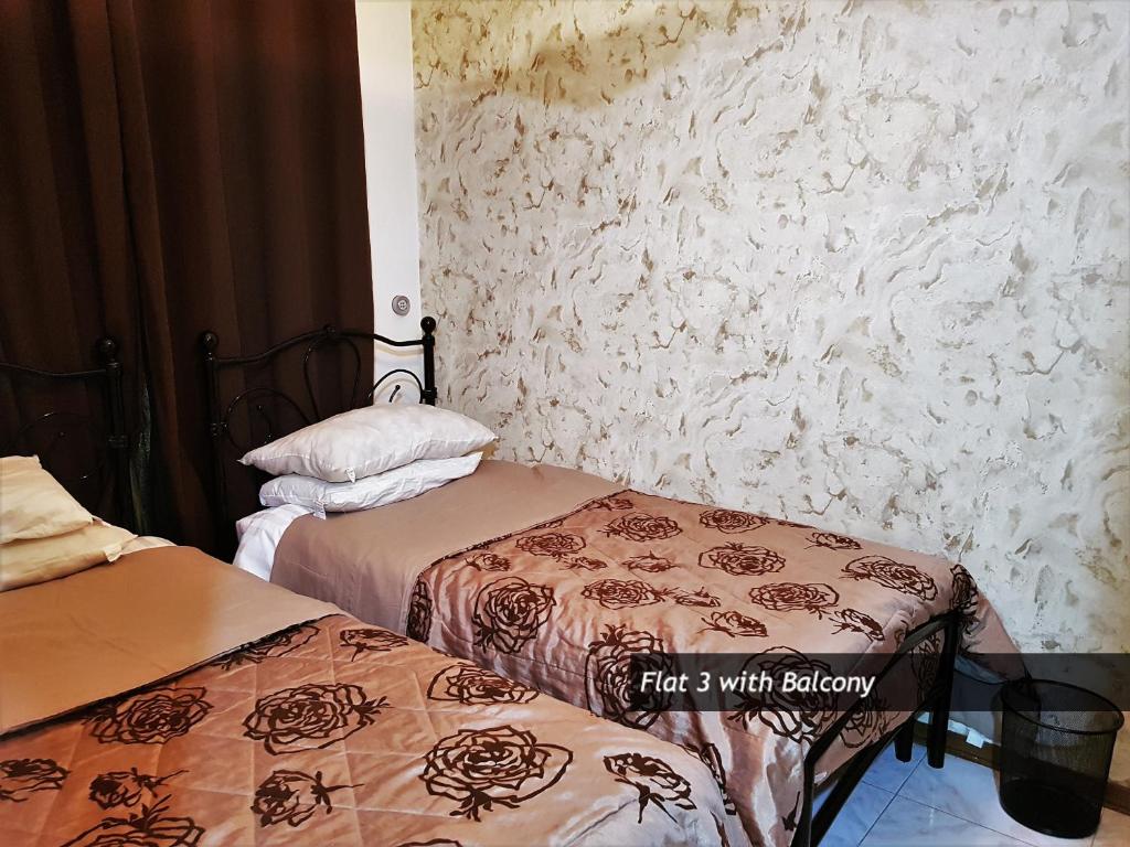 two beds sitting next to each other in a room at Pretty Bay Apartments in Birżebbuġa