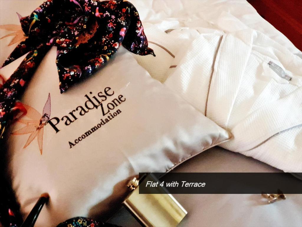 a white shirt with a sign on it next to a pen at Pretty Bay Apartments in Birżebbuġa