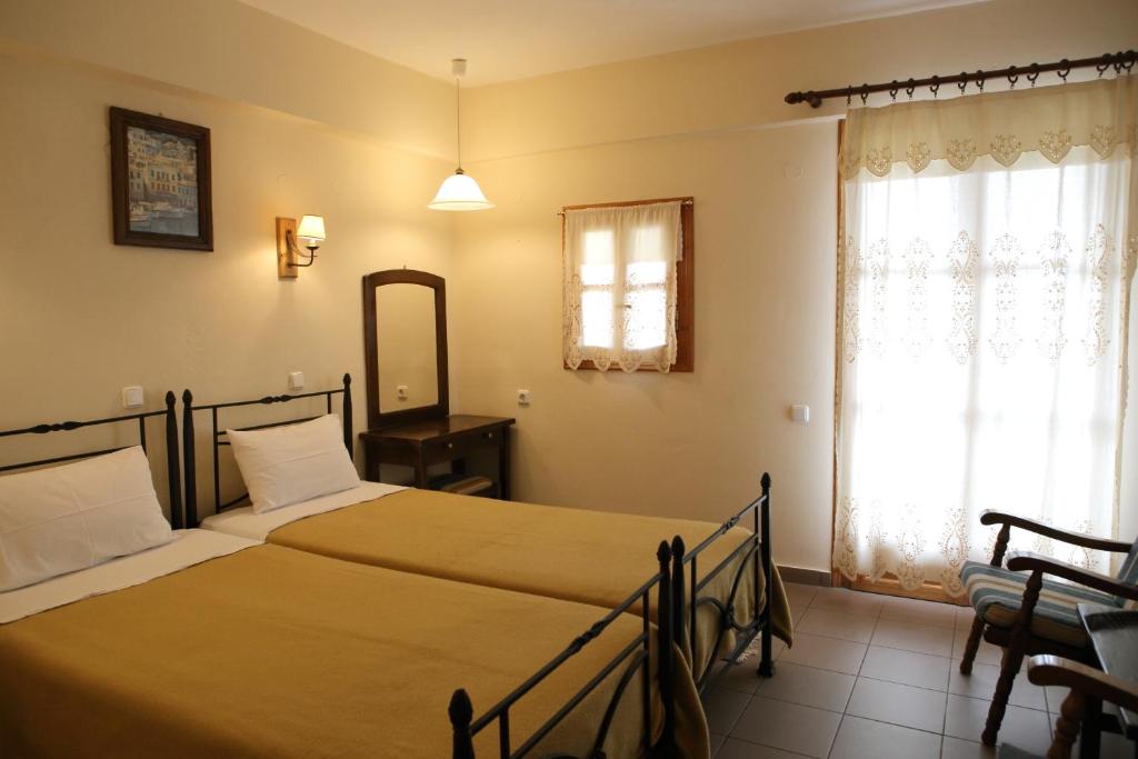 Postel nebo postele na pokoji v ubytování Mani Hotel
