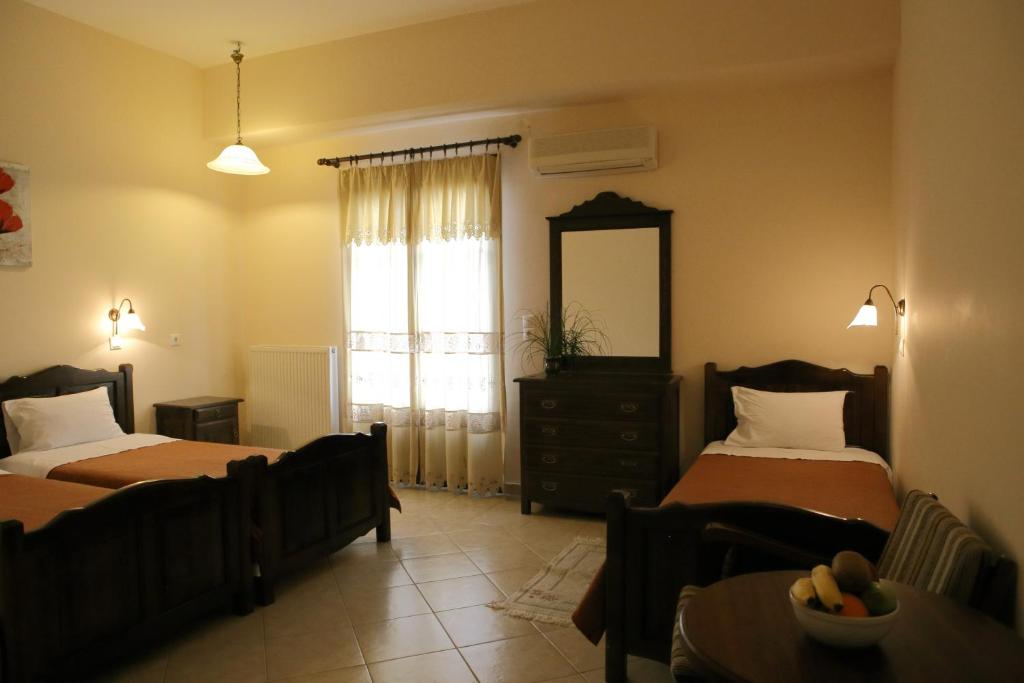 Postel nebo postele na pokoji v ubytování Mani Hotel