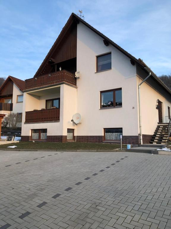a large white building with a roof at Ferienwohnung Liebing in Bad Sachsa