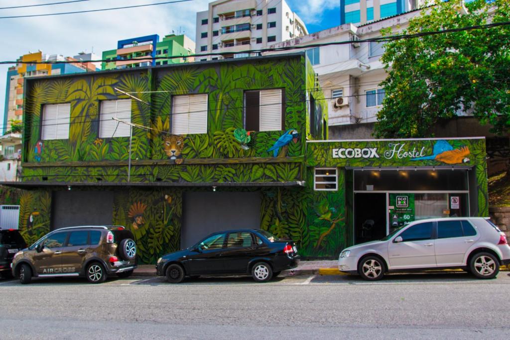 un grupo de coches estacionados frente a un edificio en Eco Box Hostel, en Florianópolis