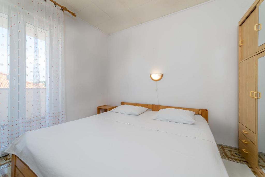 Postel nebo postele na pokoji v ubytování Apartments Jakovčev