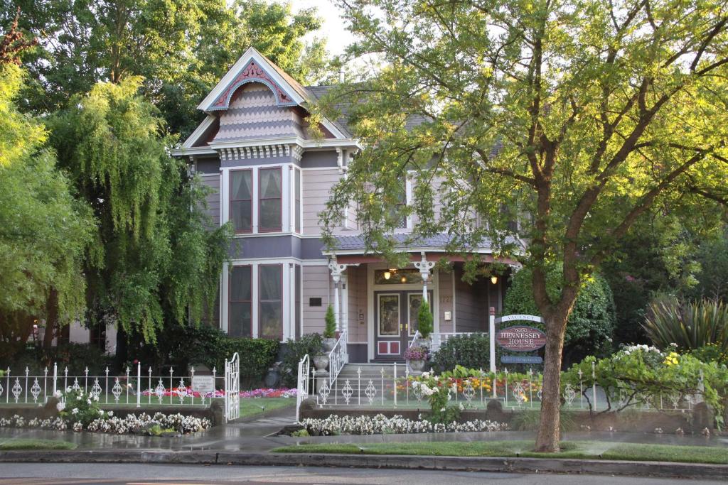 a gray house with flowers in front of it at Hennessey House Bed and Breakfast in Napa
