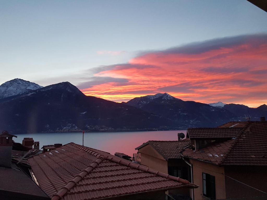 a sunset over the mountains and a body of water at Il Torchio in Musso