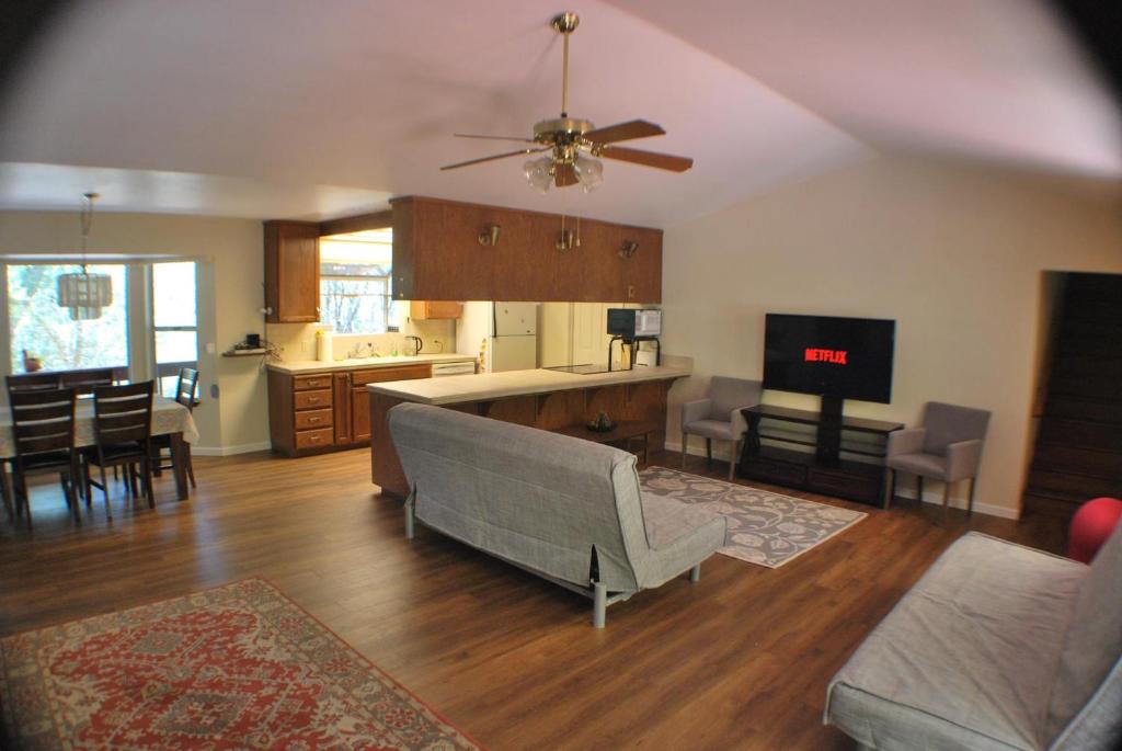 a large living room with a couch and a kitchen at Yosemite Falls Calling in Groveland