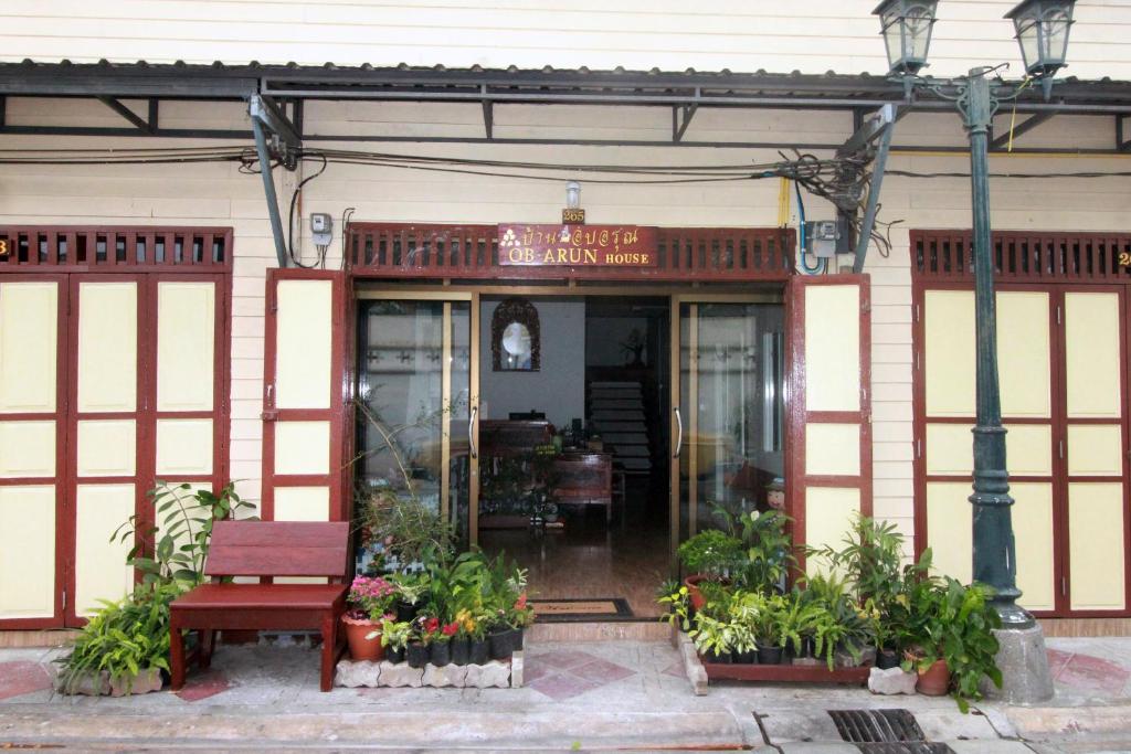 um restaurante com um banco em frente a um edifício em OB ARUN House em Bangkok