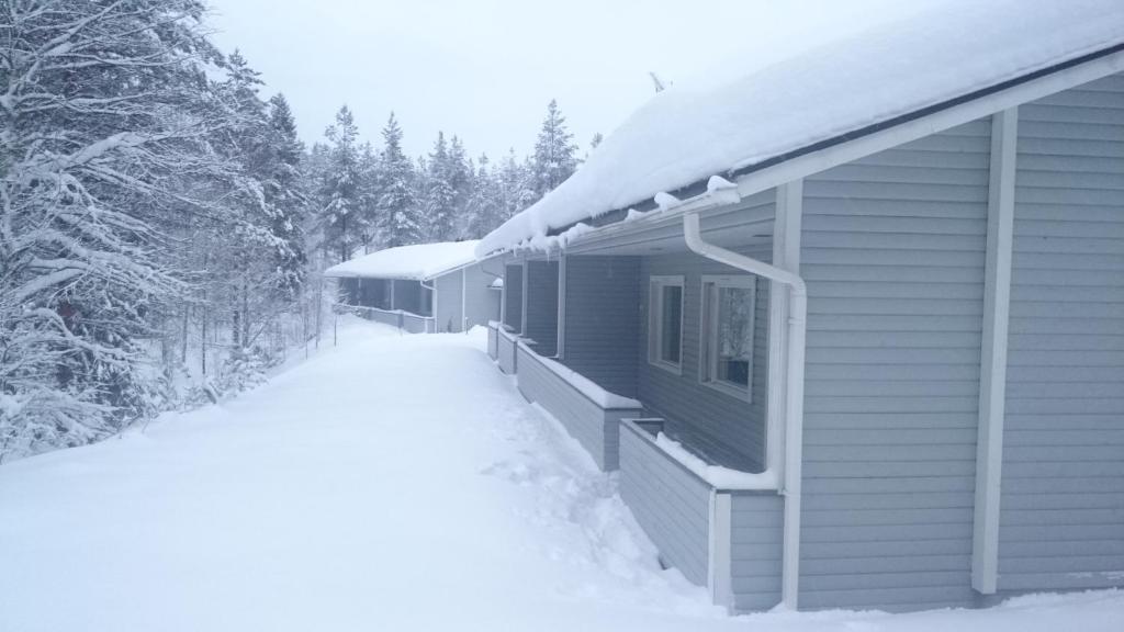 ein schneebedecktes Haus mit Schnee darauf in der Unterkunft Kotipaljakka in Kotila