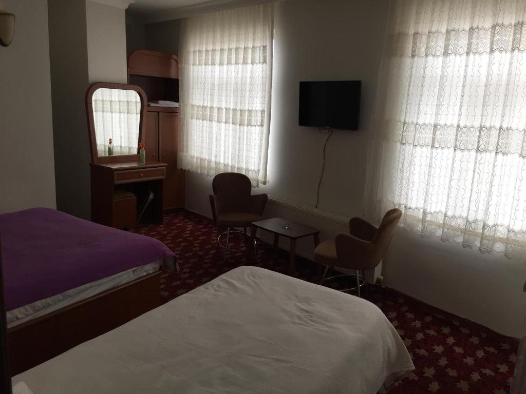 Postel nebo postele na pokoji v ubytování Hotel Birkent