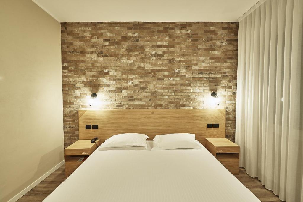 Postel nebo postele na pokoji v ubytování Hotel Miramonti