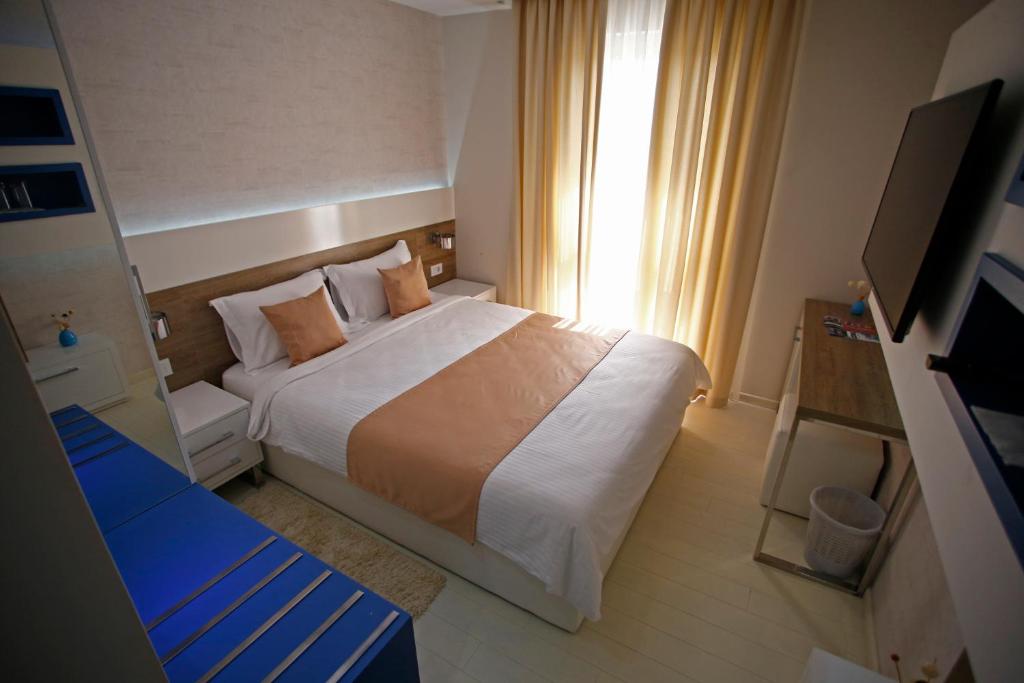a bedroom with a large bed and a window at Rox in Modriča