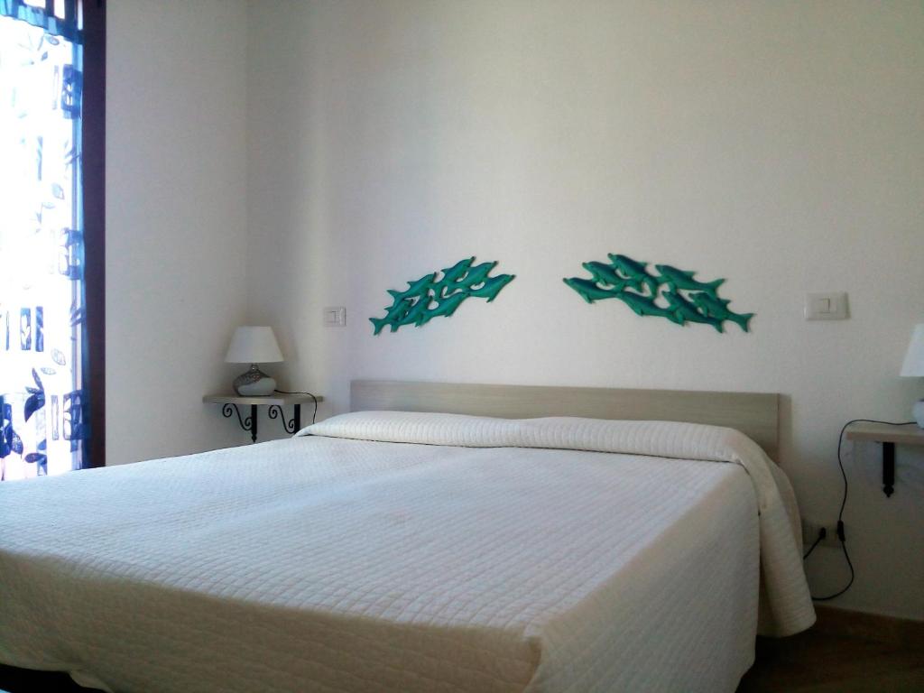 מיטה או מיטות בחדר ב-Appartamenti Santa Teresa Gallura