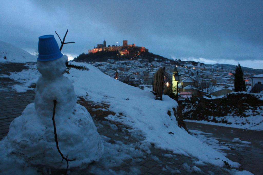 a snowman with a hat standing on a hill at Mirador Tierra de Frontera in Alcalá la Real