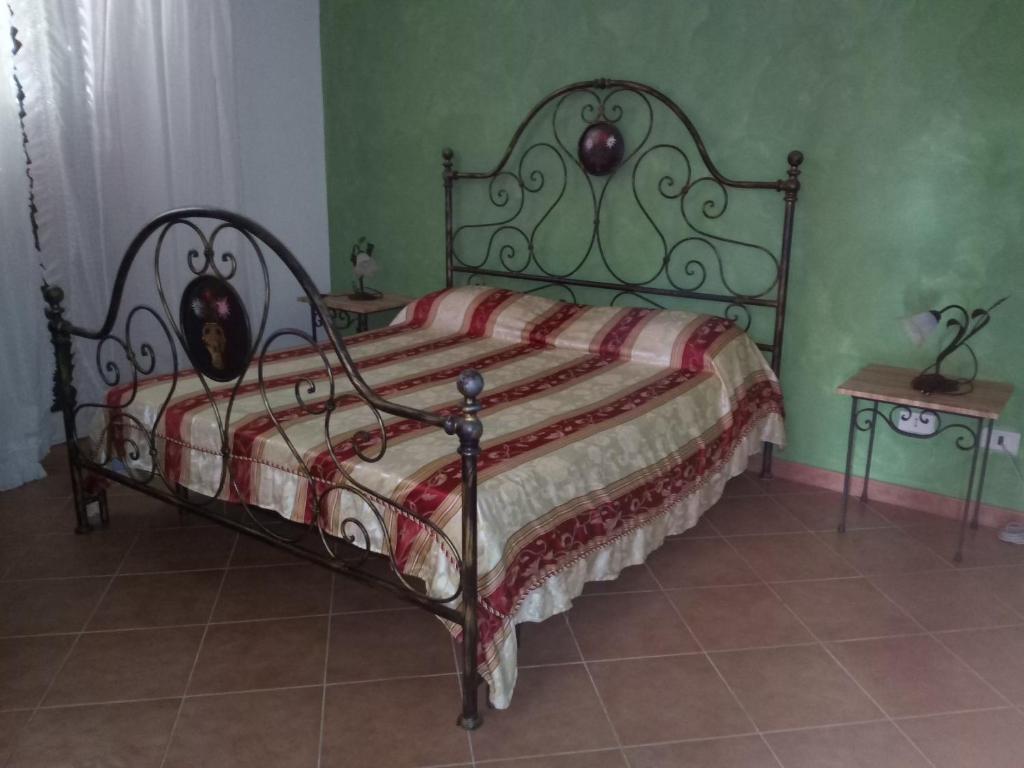 a bedroom with a bed with a metal frame at Pergole in Realmonte