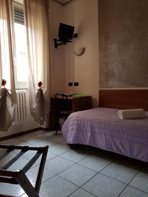 Postel nebo postele na pokoji v ubytování Hotel Marinoni