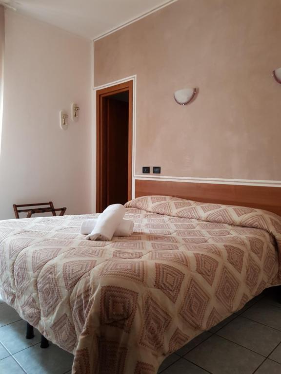 Postel nebo postele na pokoji v ubytování Hotel Marinoni