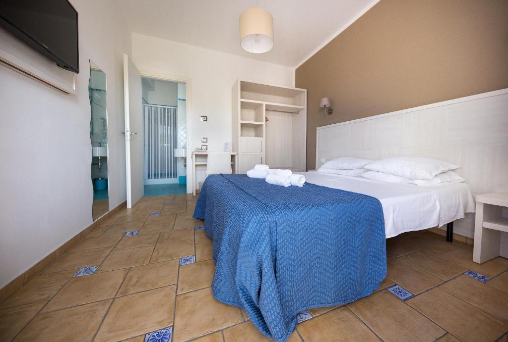 a bedroom with a bed and a blue table at Petruso Resort in Balestrate