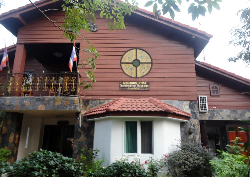 ein Gebäude mit einer Uhr auf der Seite in der Unterkunft Moradok Thai Guesthouse in Phra Nakhon Si Ayutthaya