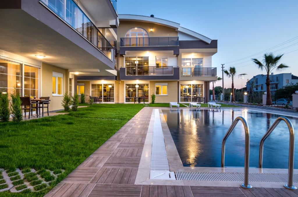 a house with a swimming pool in front of it at Lara Beach Homes in Lara