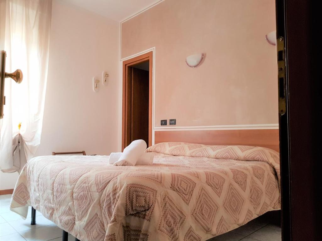 Postel nebo postele na pokoji v ubytování Hotel Marinoni