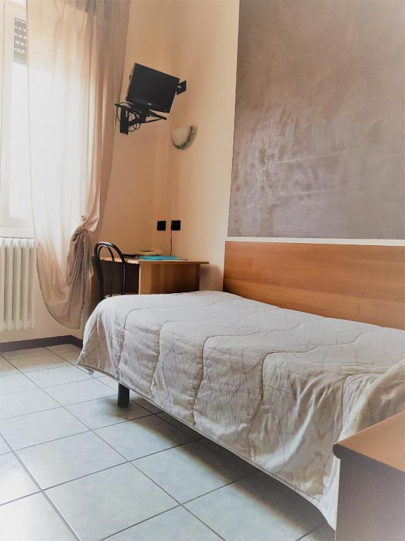 Postel nebo postele na pokoji v ubytování Hotel Marinoni