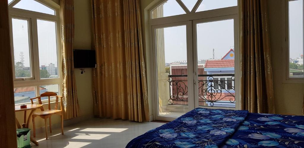 a bedroom with a bed and a large window at Hai Dang Hotel in Ho Chi Minh City