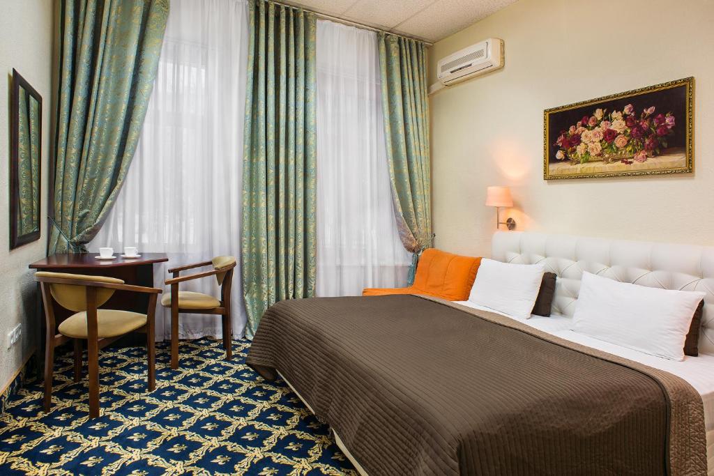 Postel nebo postele na pokoji v ubytování Basis-M Hotel