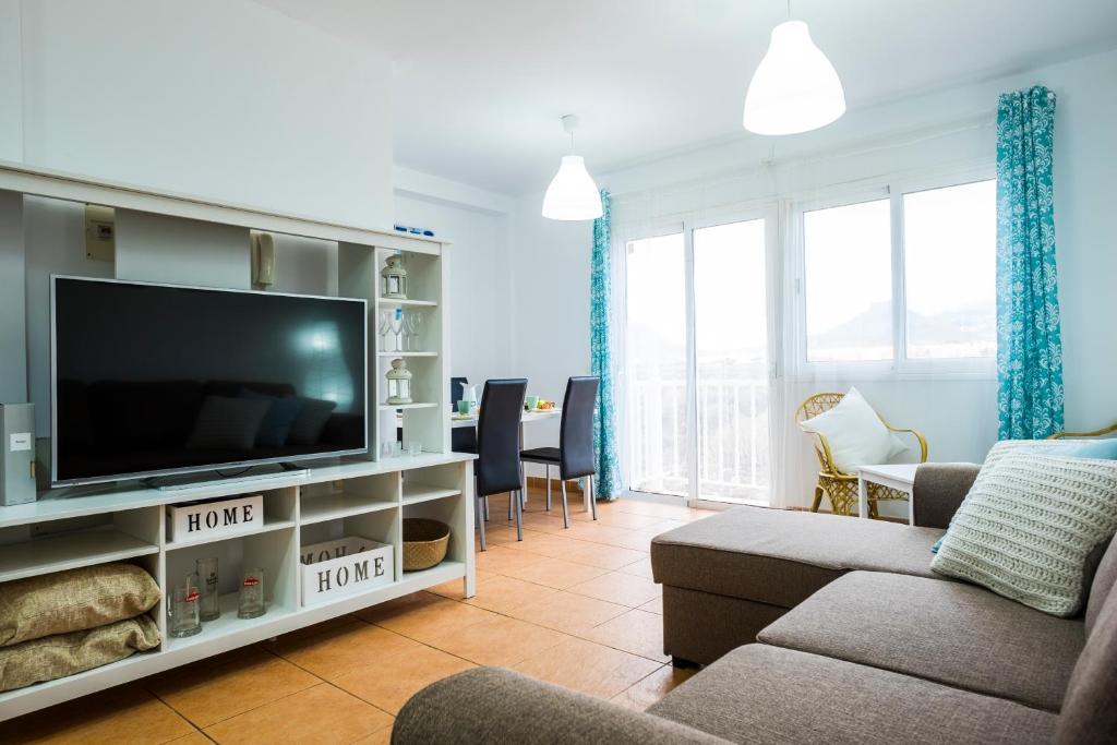 a living room with a tv and a couch at Cosy Apartment 6 places Canarian Life in Las Galletas