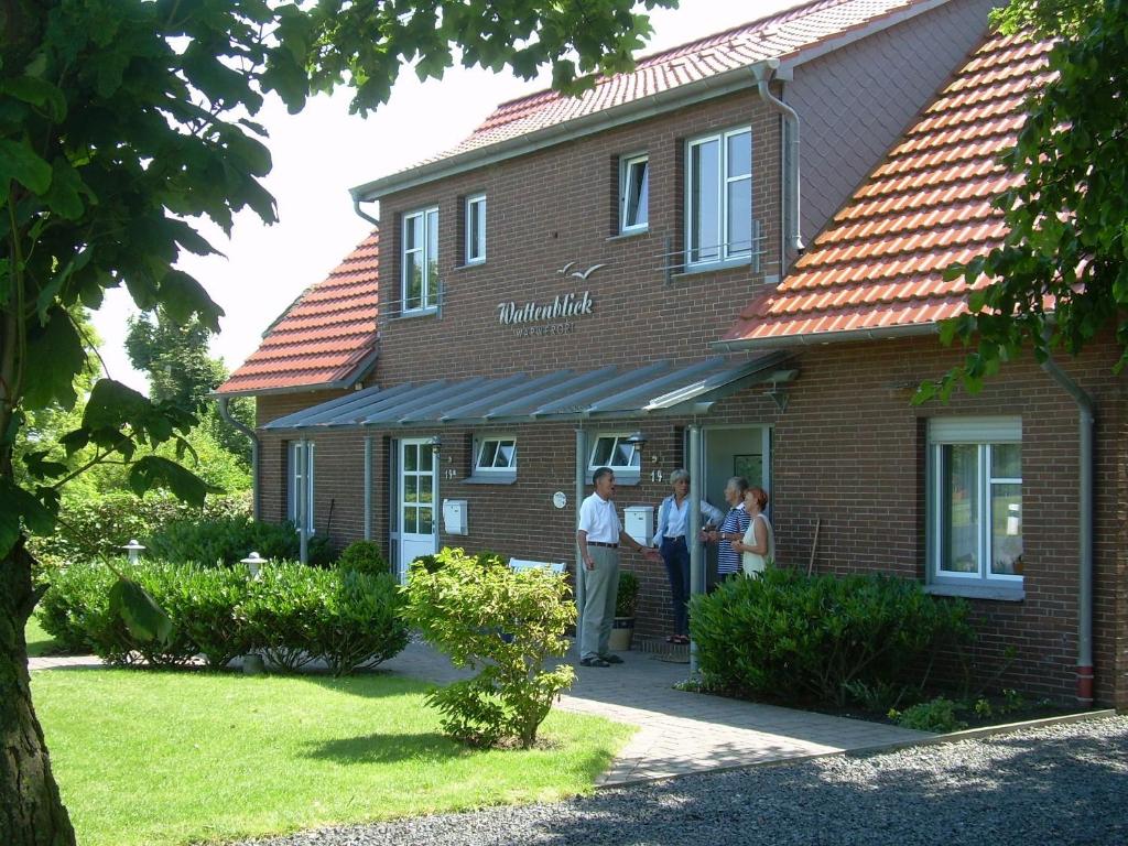 a group of people standing outside of a building at Wattenblick in Büsum