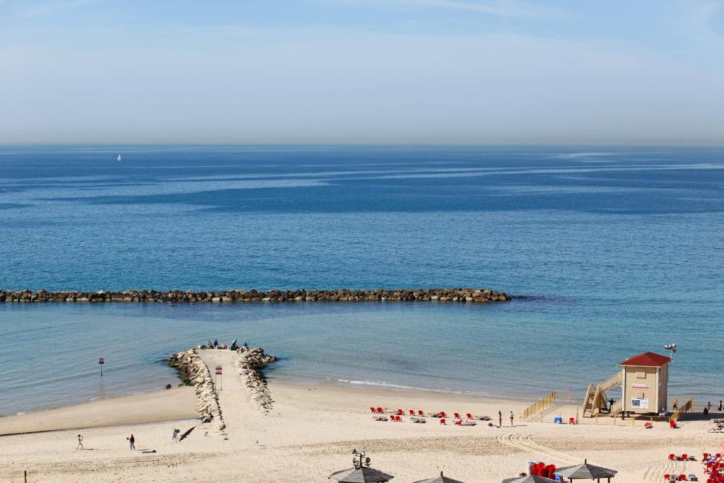 a beach with a large body of water at Embassy Hotel Tel Aviv in Tel Aviv