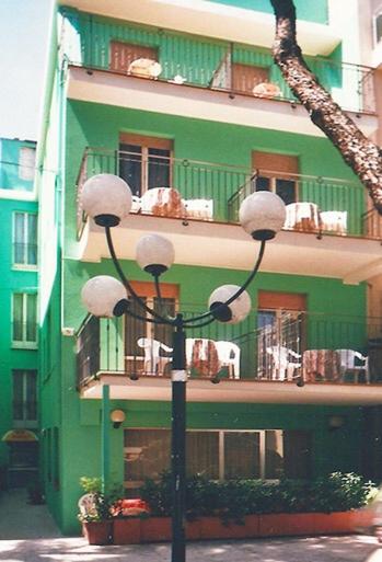 a street light in front of a green building at New Prophet Appartamenti in Cattolica