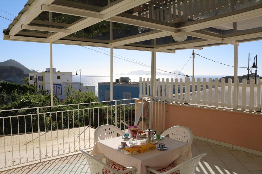 a white table and chairs on a balcony at Le Case dei Pescatori - Coccinella Rossa in Ponza