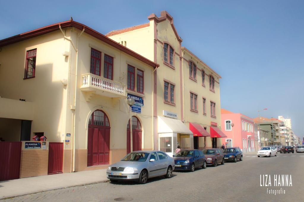 a group of cars parked in front of a building at Alameda Guest House in Espinho