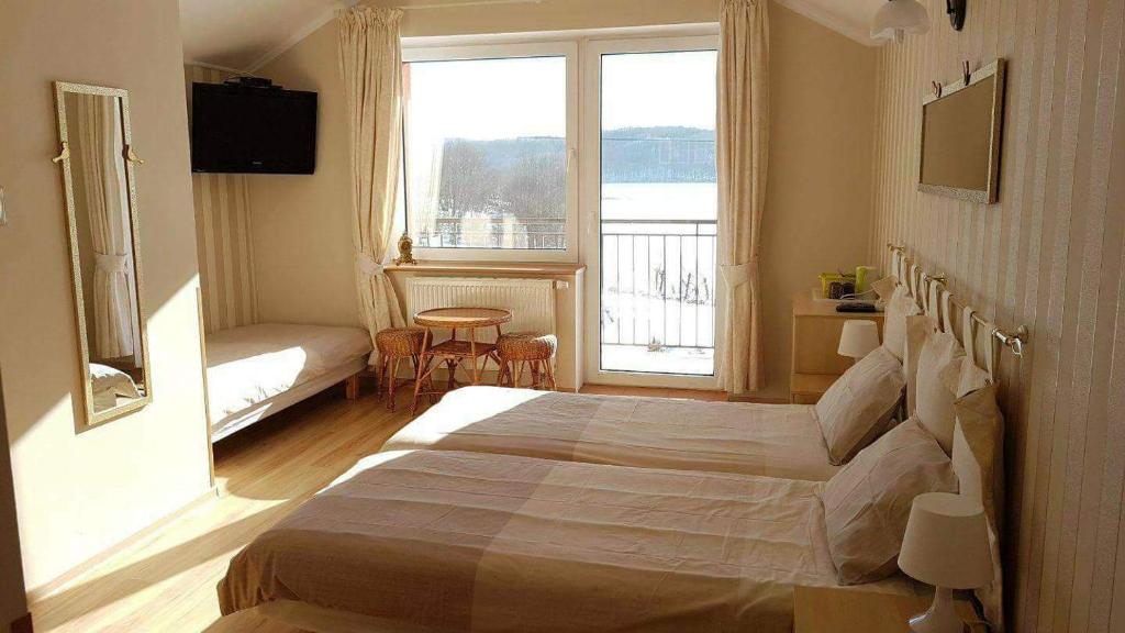 Postel nebo postele na pokoji v ubytování Pensjonat nad jeziorem Lakeside