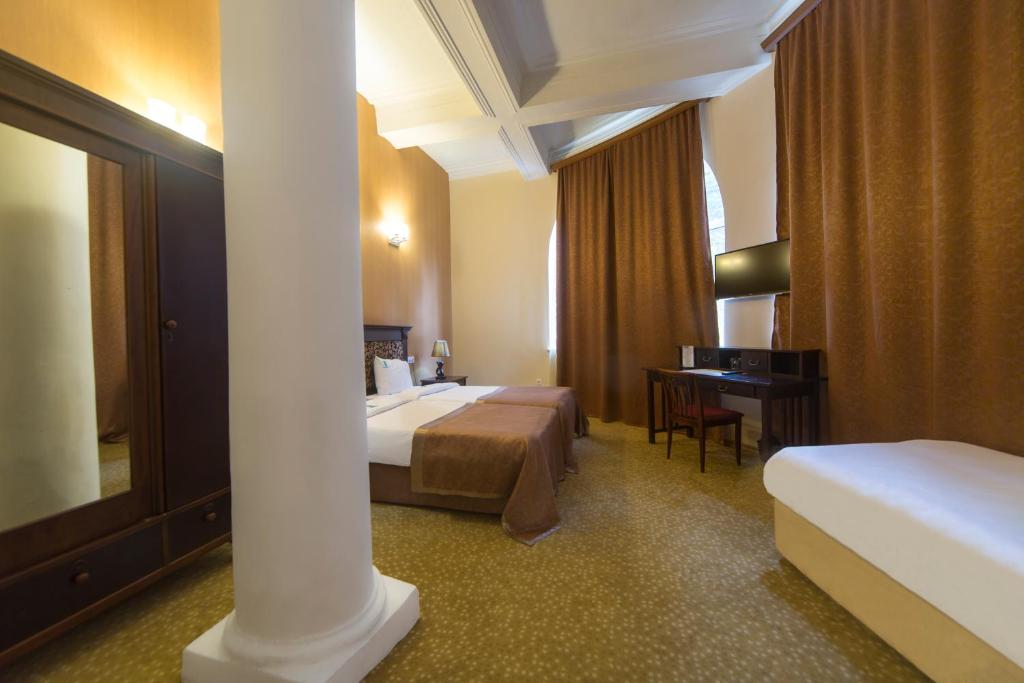 Postel nebo postele na pokoji v ubytování Legends Tskaltubo Spa Resort