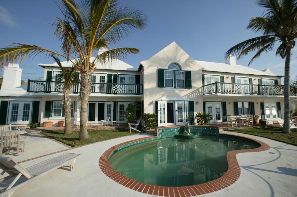 a large house with a swimming pool in front of it at Watercolours in Mount Pleasant