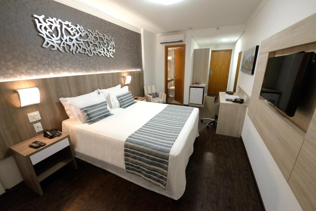Postel nebo postele na pokoji v ubytování Allia Gran Pampulha Suites