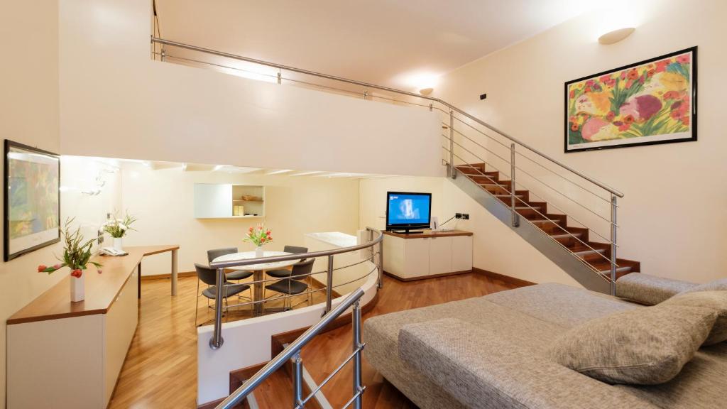 - un salon avec un canapé et un escalier dans l'établissement Residence Sacchi Aparthotel, à Turin
