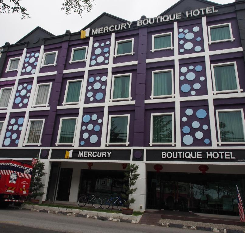 a purple building with a sign that reads mercury boutique hotel at Mercury Boutique Hotel in Melaka