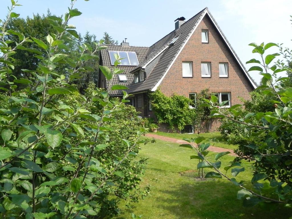 a large brick house with trees in front of it at Haus *Üüs Aran* Wohnung Nr. 1 in Nebel