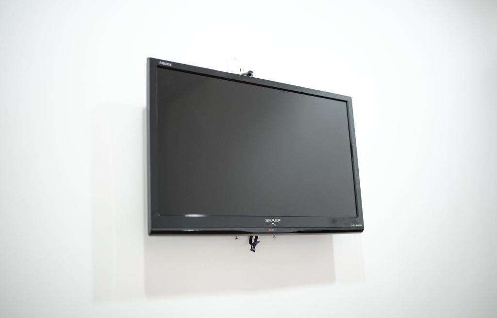 TV a/nebo společenská místnost v ubytování MG Hotel