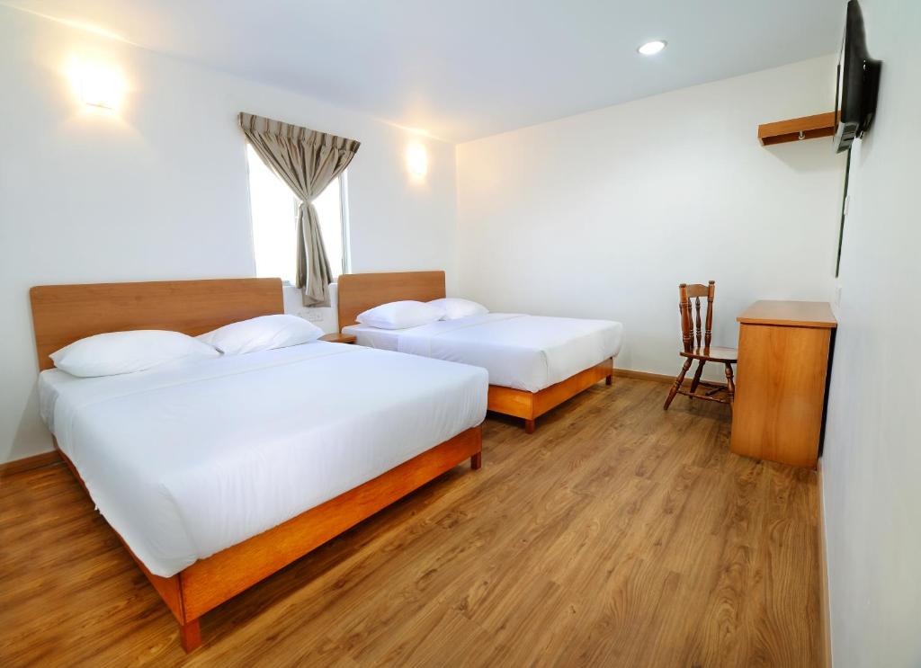 Postel nebo postele na pokoji v ubytování MG Hotel