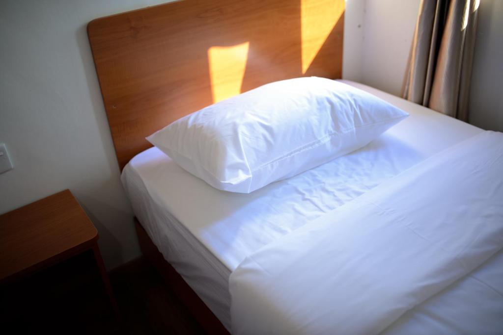 Postel nebo postele na pokoji v ubytování MG Hotel