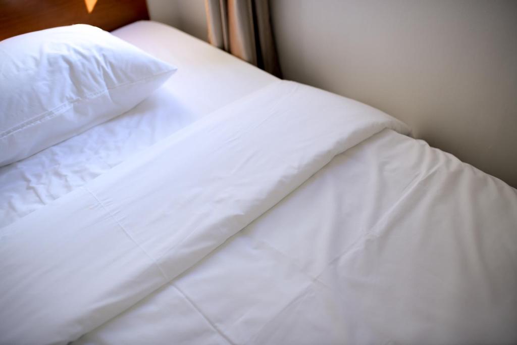 Postel nebo postele na pokoji v ubytování MG Hotel