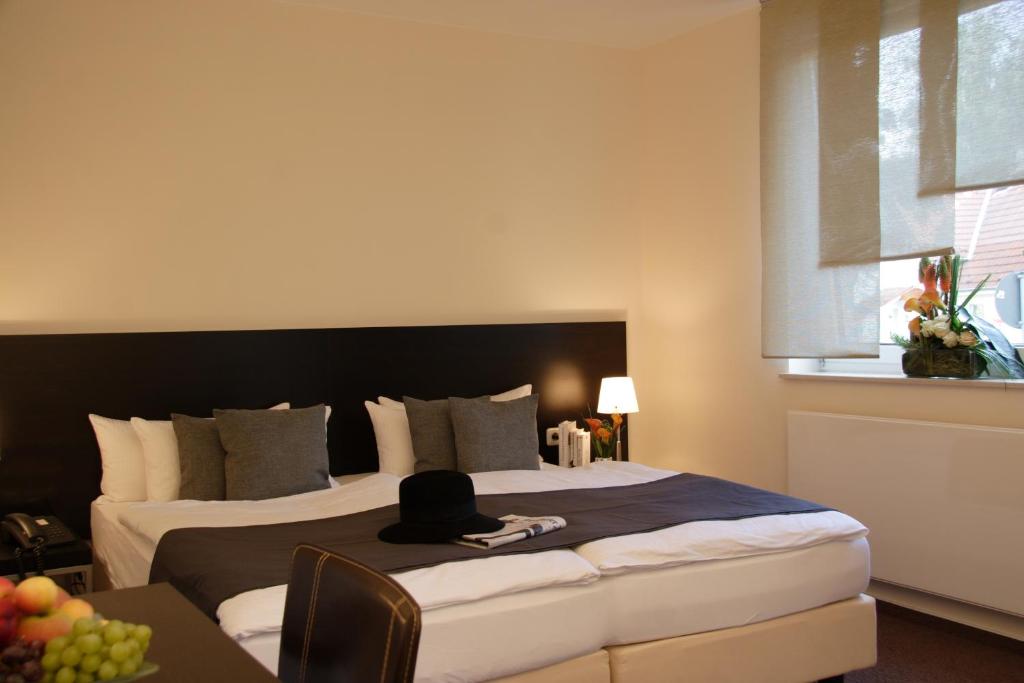 Postel nebo postele na pokoji v ubytování Hotel Bonjour