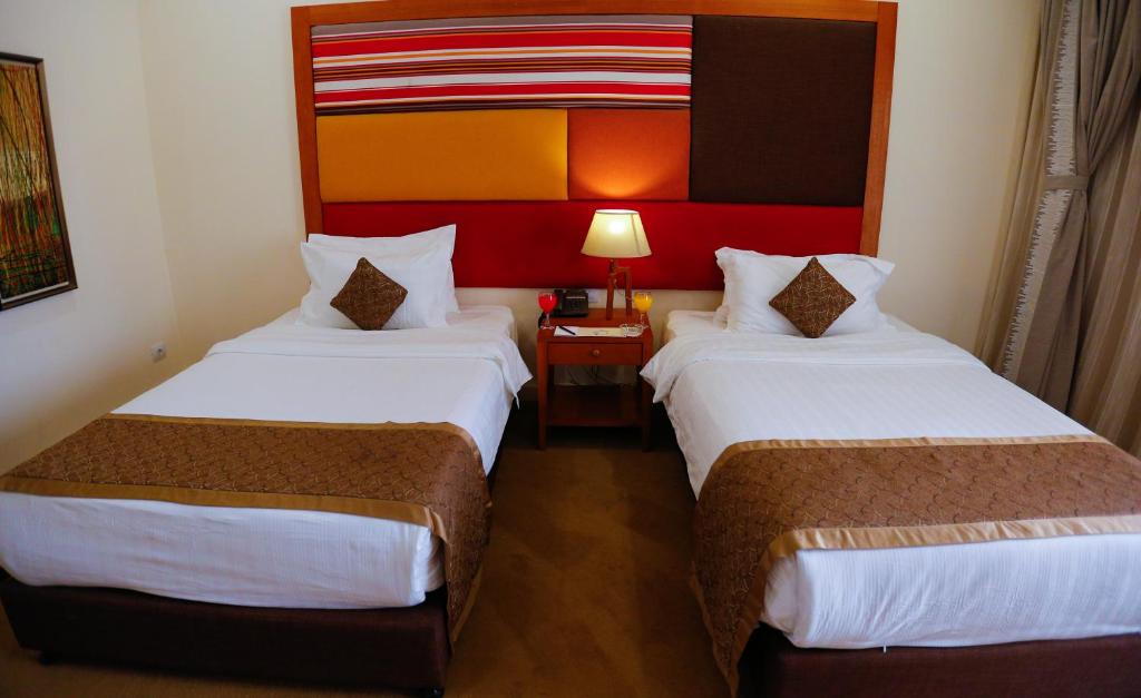 Postel nebo postele na pokoji v ubytování Tolip Family Park Hotel