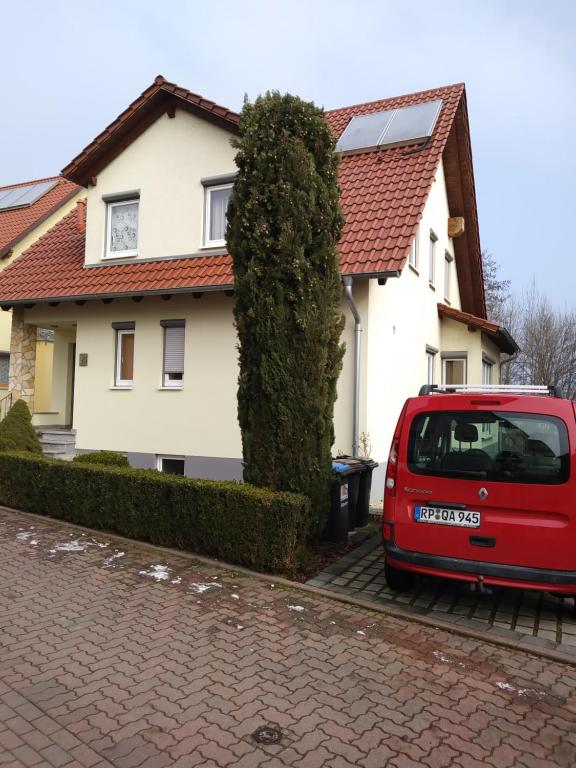 a red van parked in front of a house at House of ‘Welcome in Dannstadt-Schauernheim