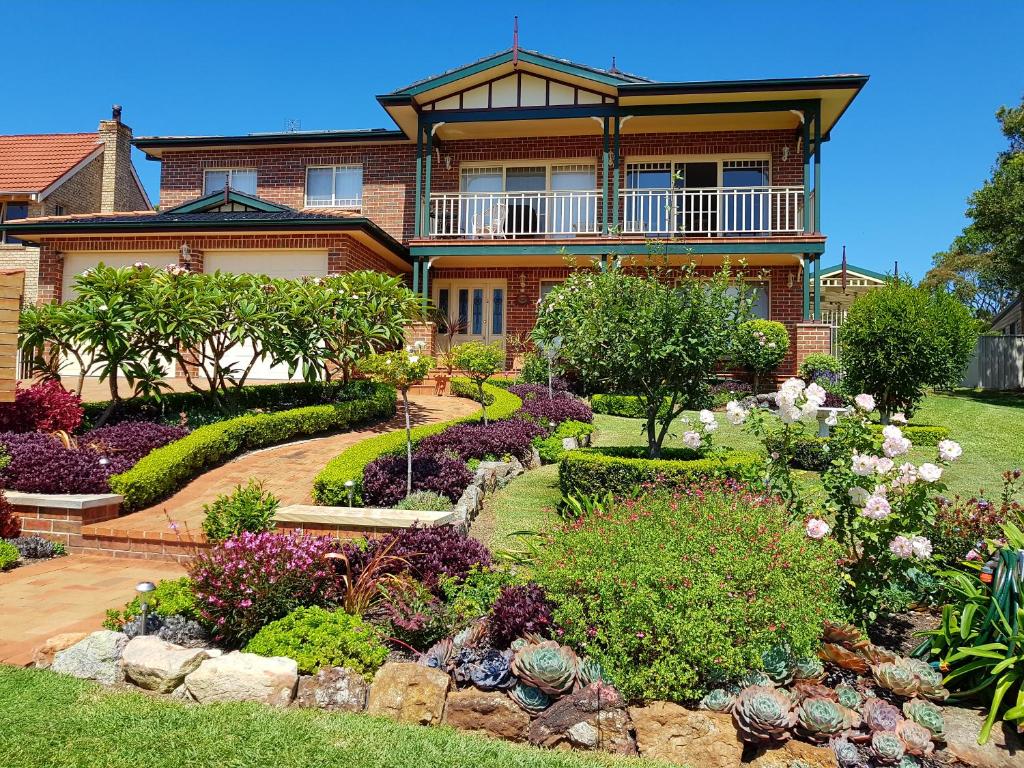a house with a garden in front of it at Jervis Bay Blue - Vincentia in Vincentia