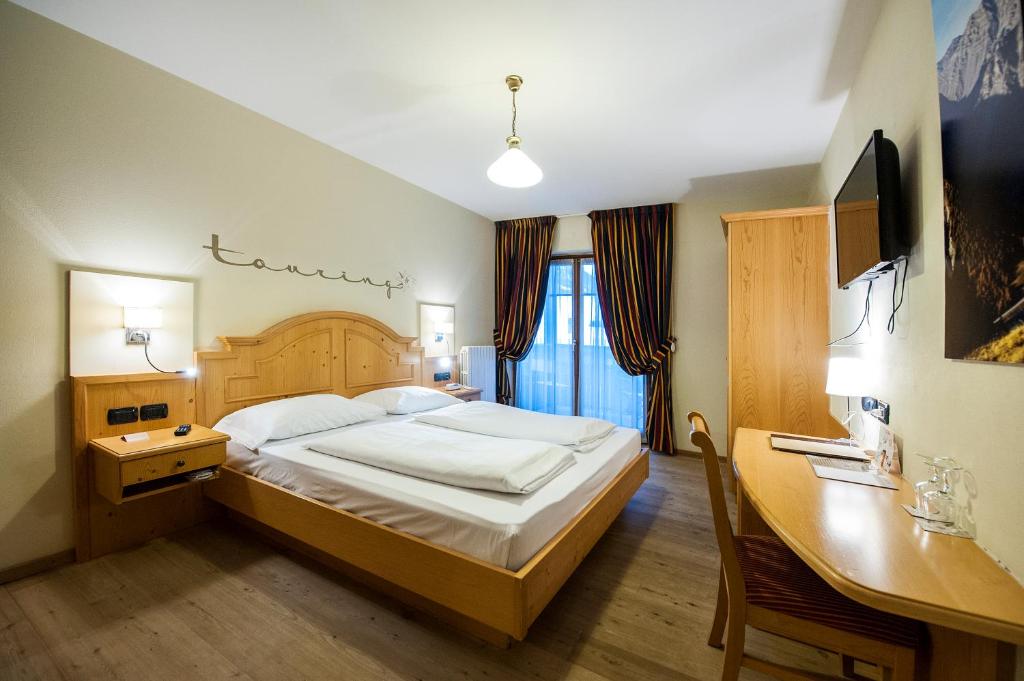Postel nebo postele na pokoji v ubytování Hotel Touring