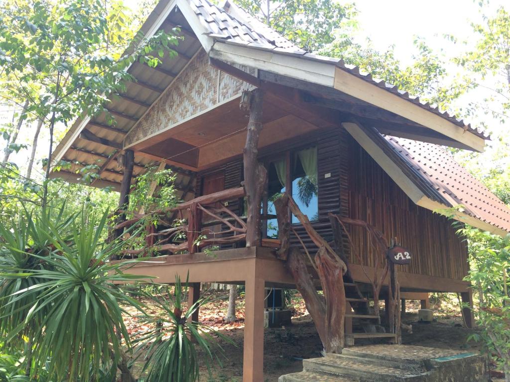 a tree house with a porch and stairs to it at Activities Resort in Ko Yao Yai